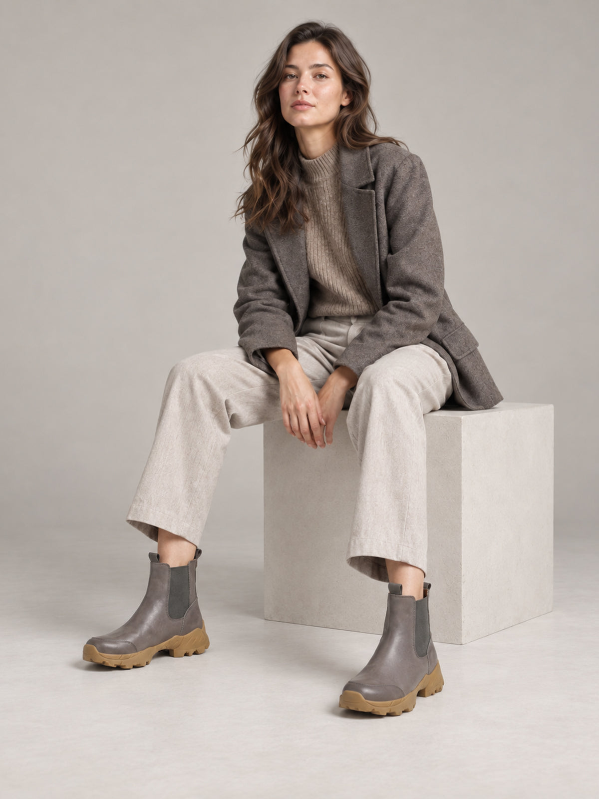 Grey Khaki Ankle Boots, worn with light trousers while seated.