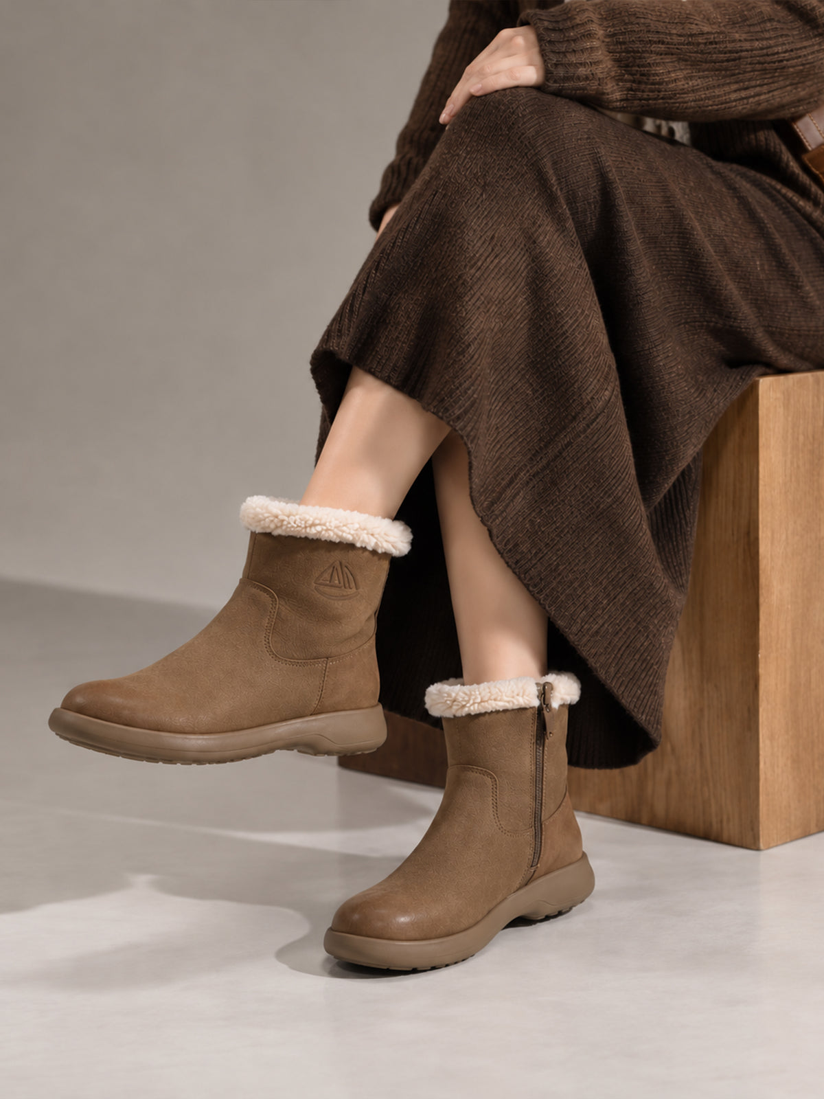 Coffee brown Snow-Cap snow boots, close-up of the boots worn while seated.