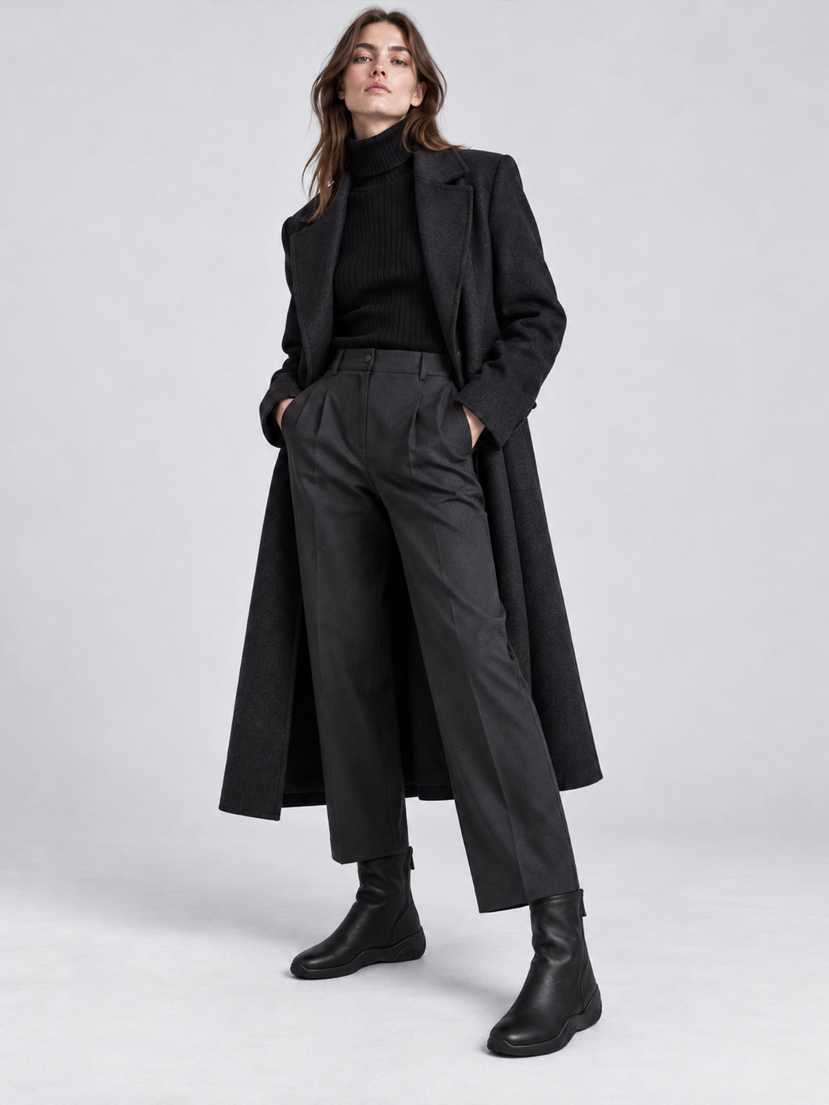 Black lambskin sock boots, shown as part of a complete outfit.
