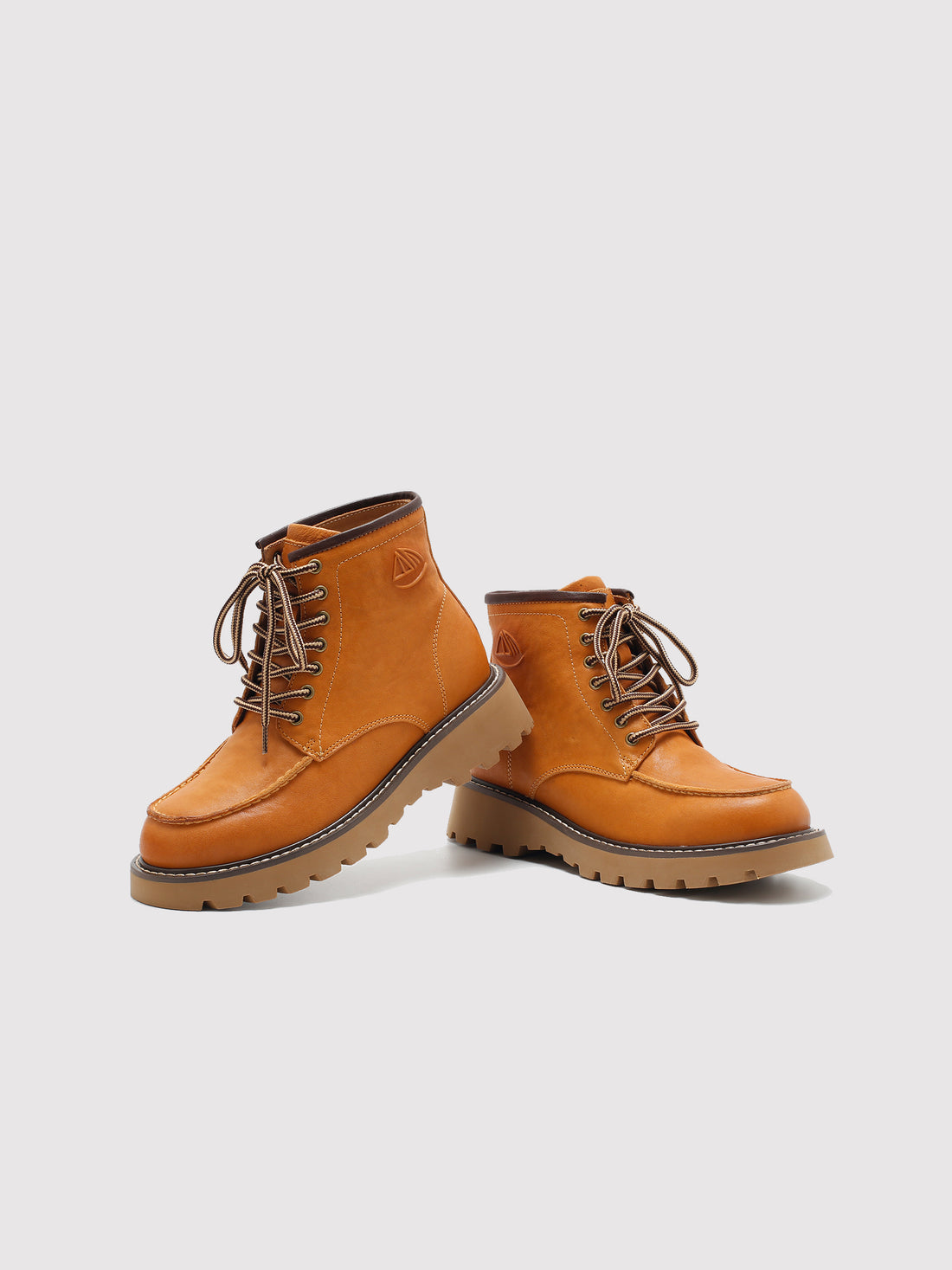 Tan washed leather combat boots, pair viewed from the front at an angle.
