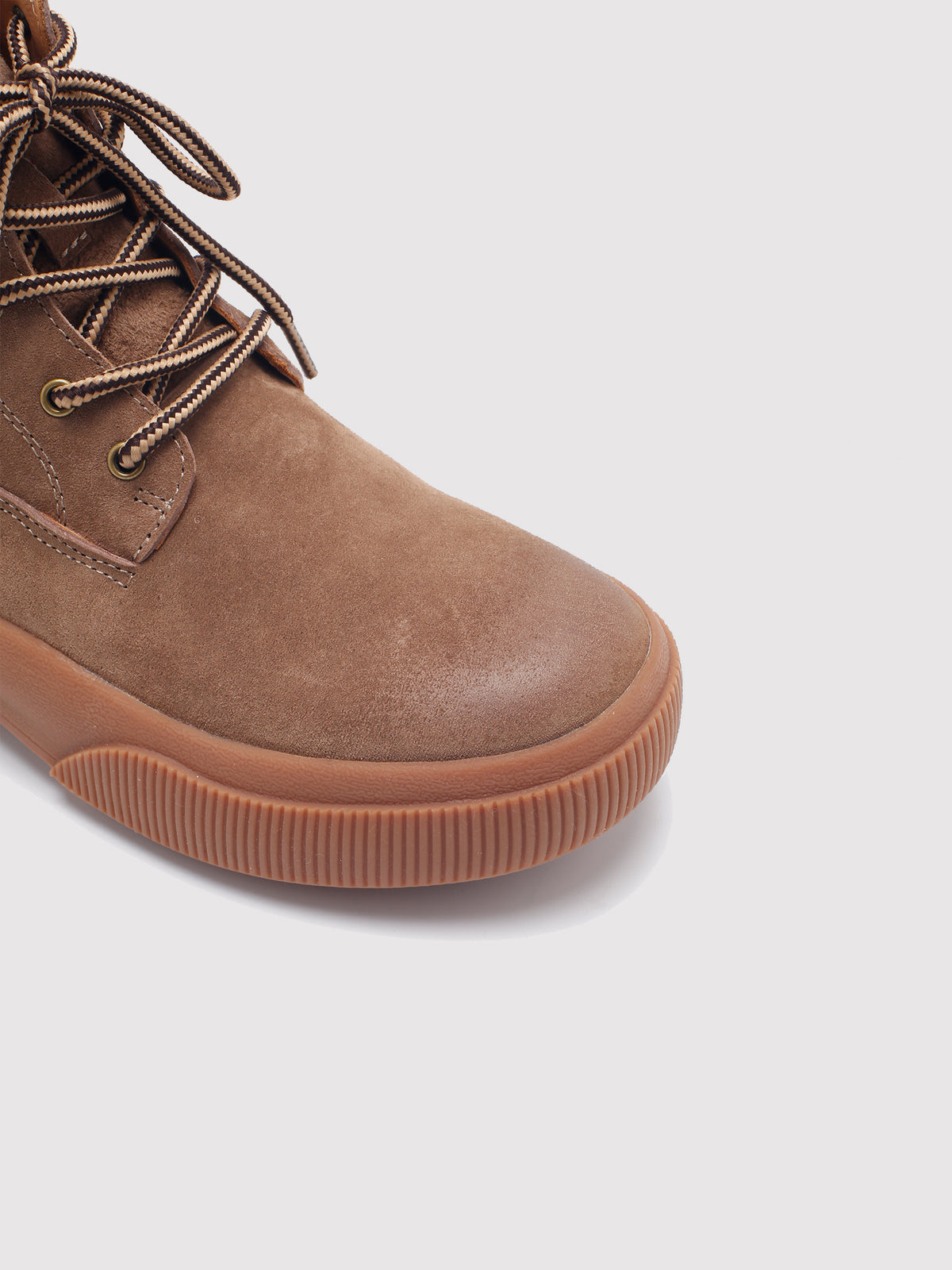 Brown Yaoyao sole ankle boots, close-up of the toe and sole edge.