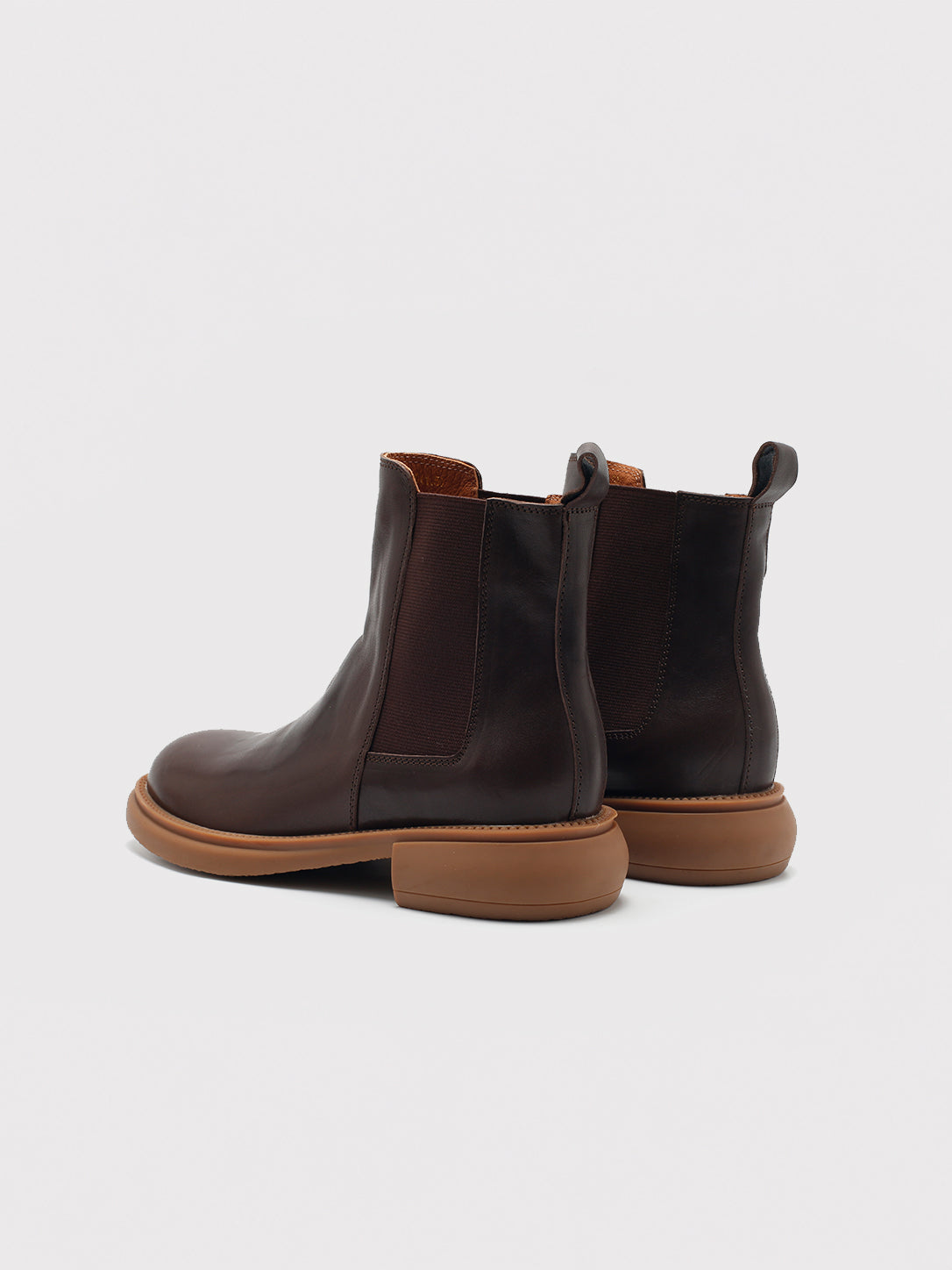 Dark brown washed-leather Chelsea boots, pair viewed from the back.