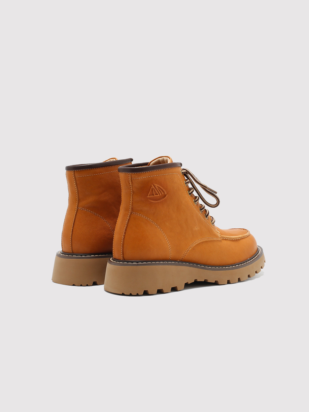 Tan washed leather combat boots, pair viewed from the back.
