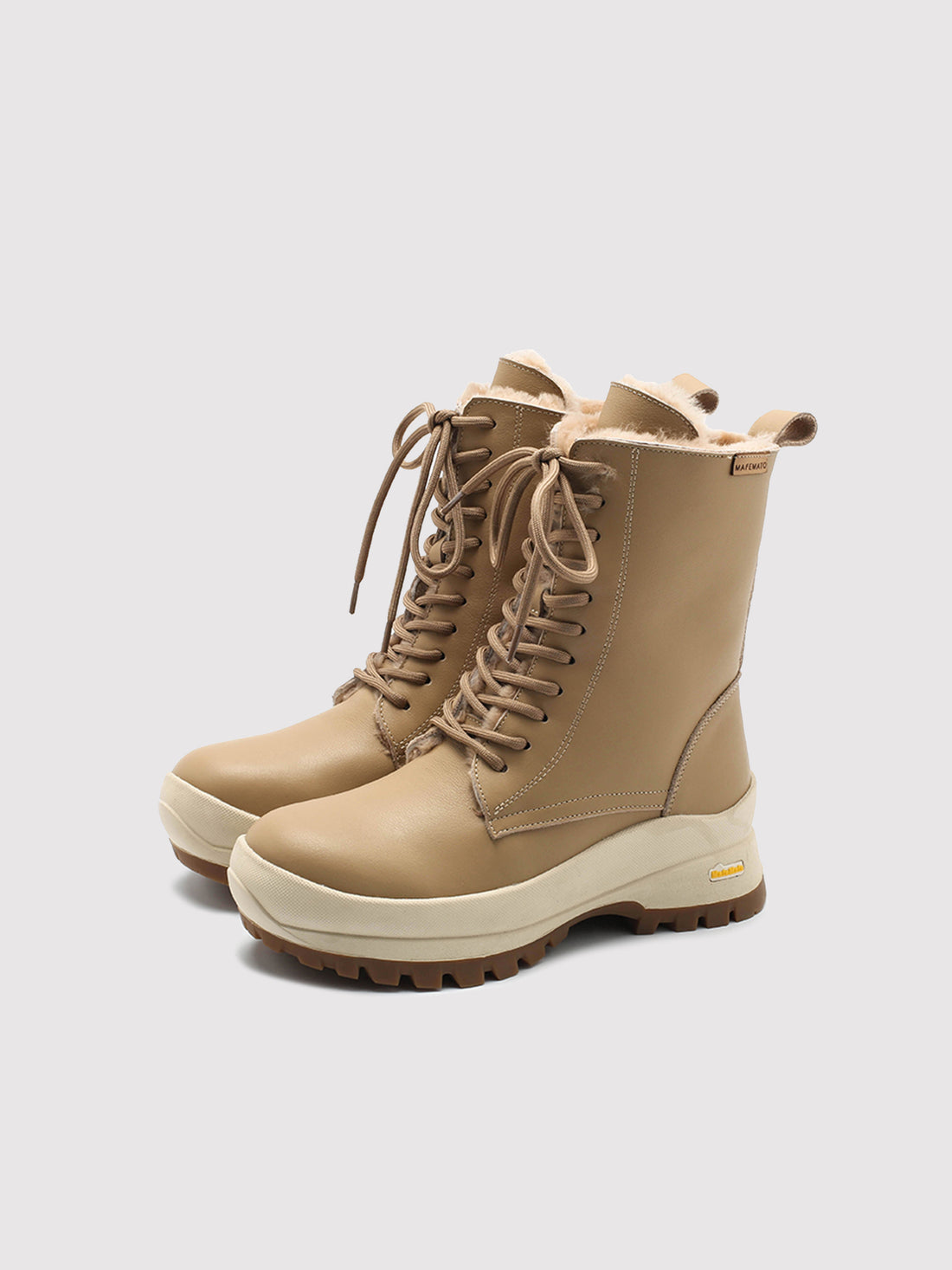 Beige Aspen shearling lace-up boots, pair viewed from the front at an angle.