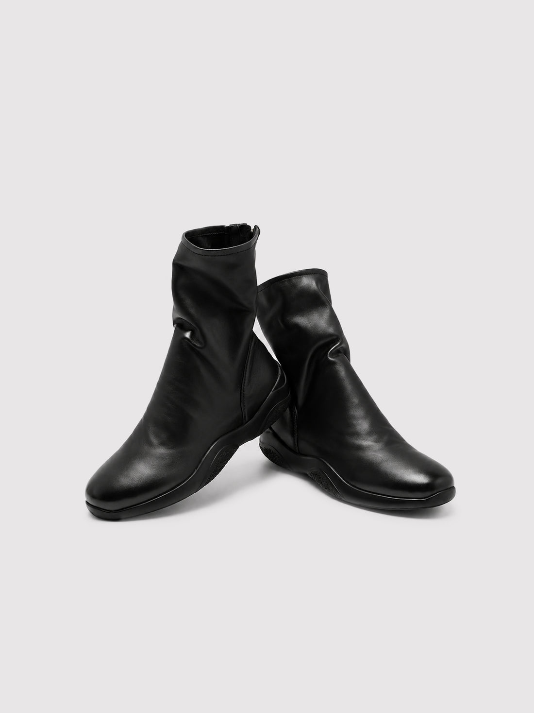 Black lambskin sock boots, pair viewed from the front at an angle.