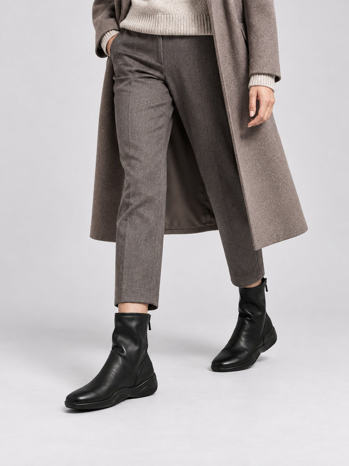 Black lambskin sock boots, close-up of the shoes being worn.
