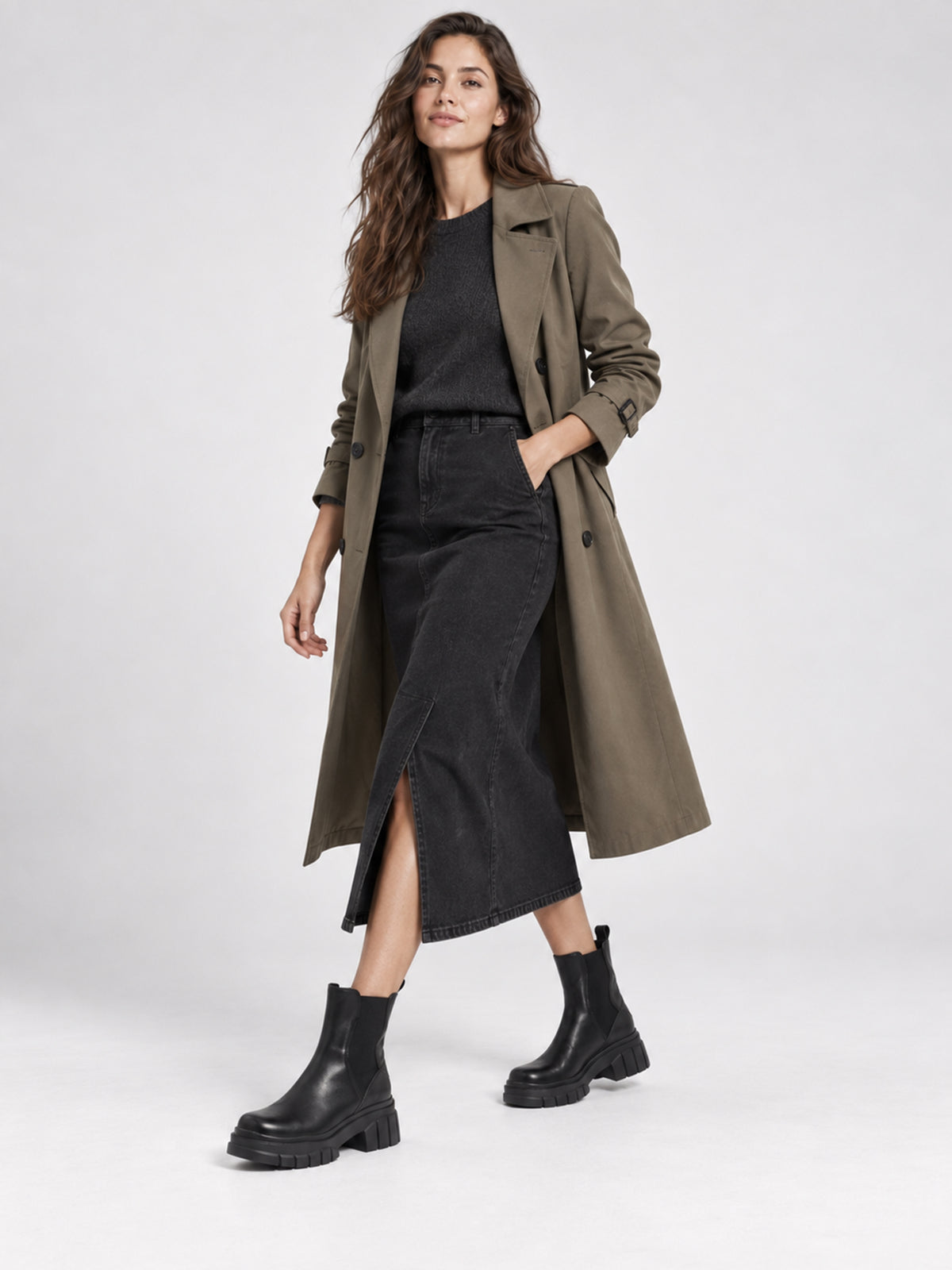 Black shaft boots with lug soles, worn with a long coat and black dress.