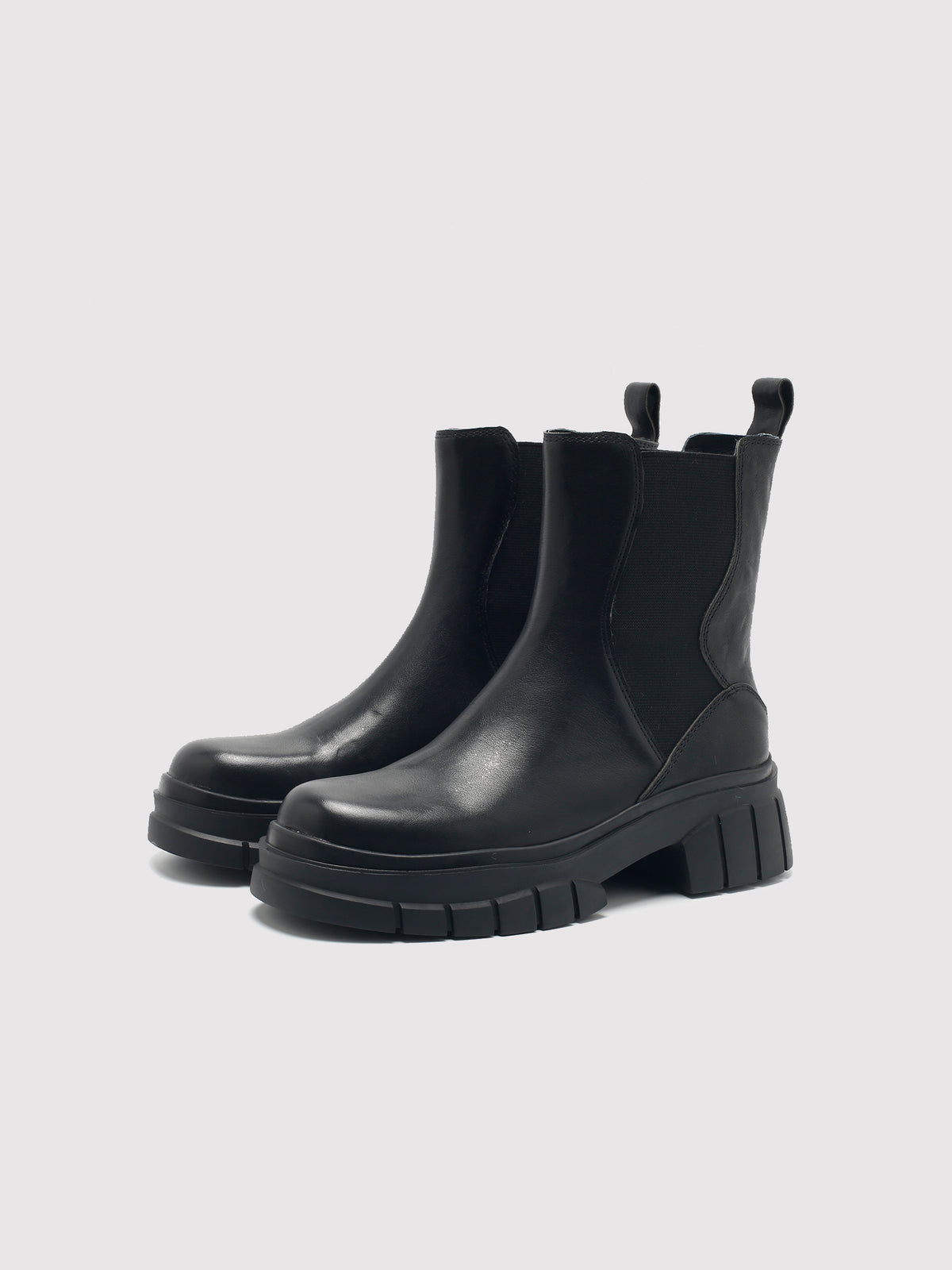 Black shaft boots with lug soles, pair viewed from the front at an angle.