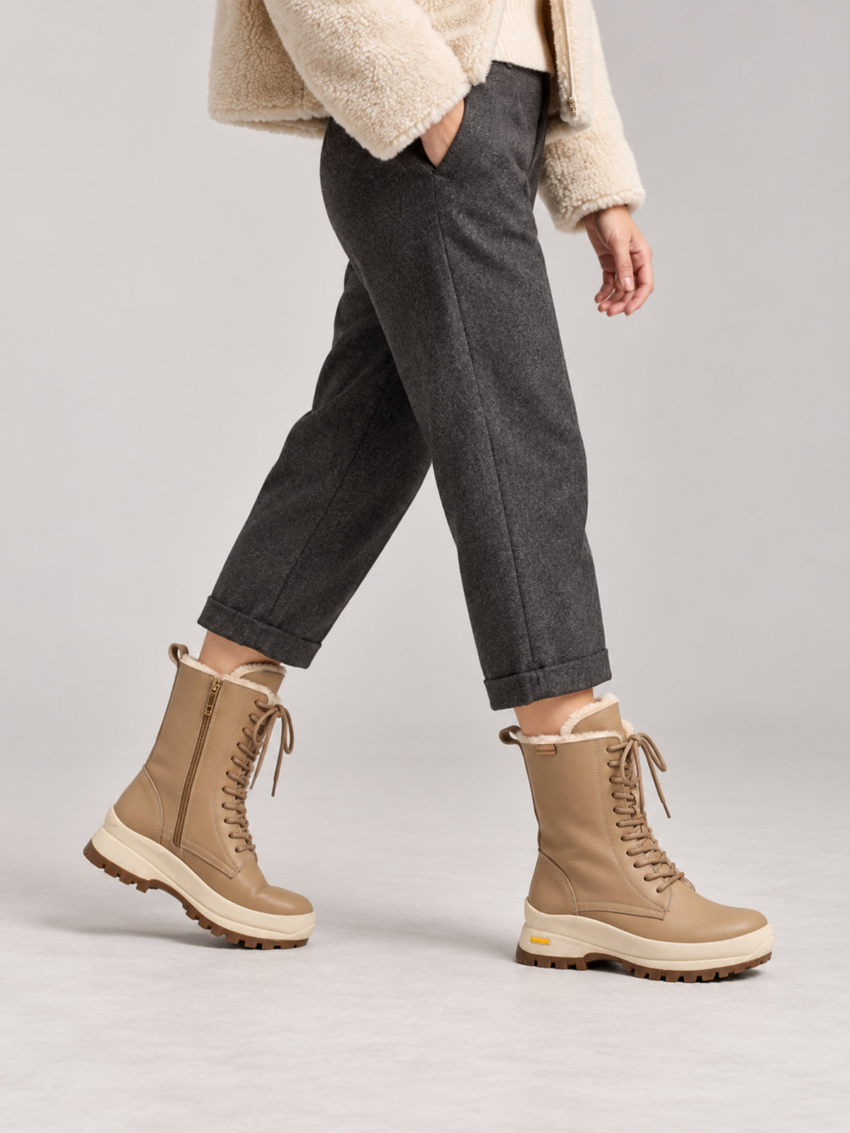 Beige Aspen shearling lace-up boots, close-up of the shoes being worn.