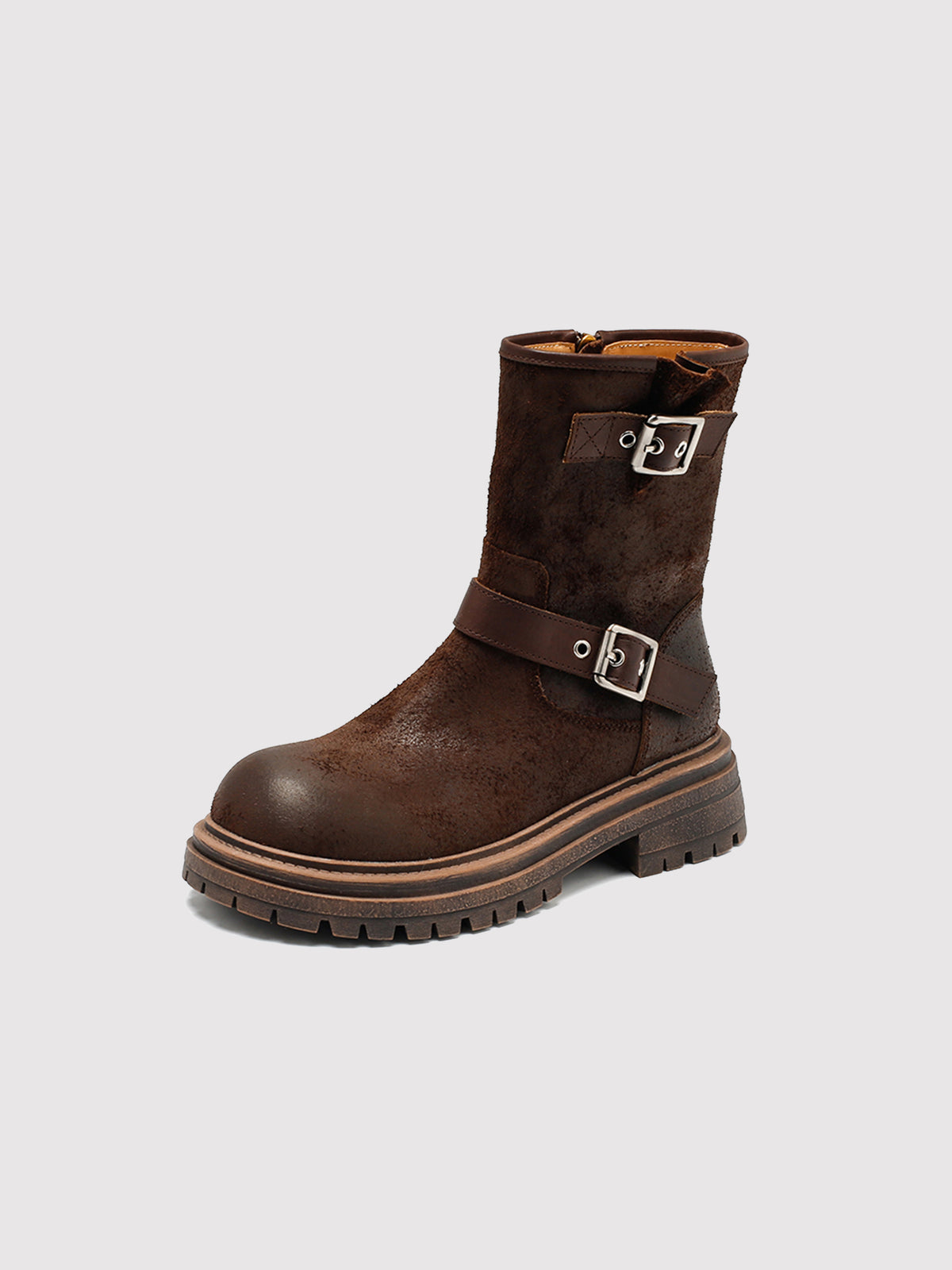 Brown reverse-leather buckle boots, single boot viewed at an angle.