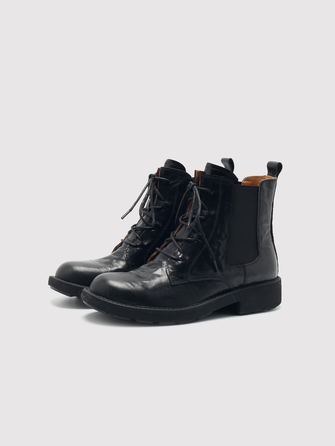 Vegetable-tanned black lace-up boots, pair viewed from the front at an angle.
