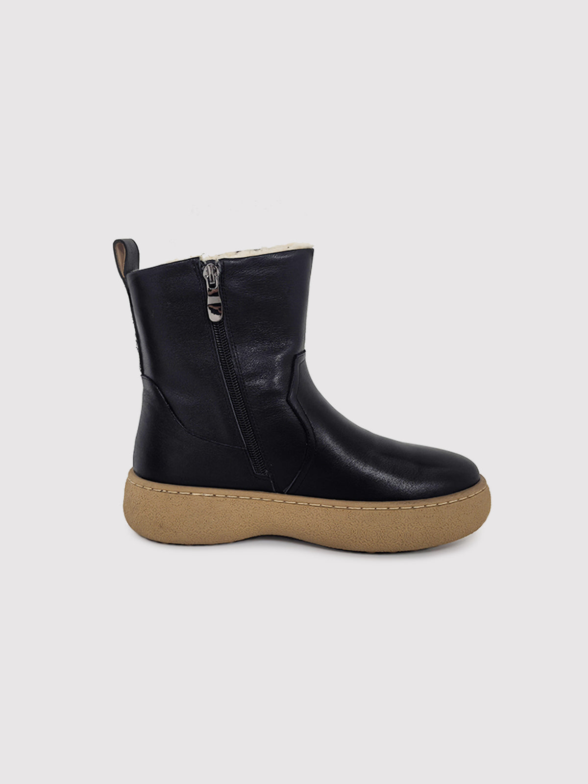 Black polished winter boots with tan soles, opposite side profile.