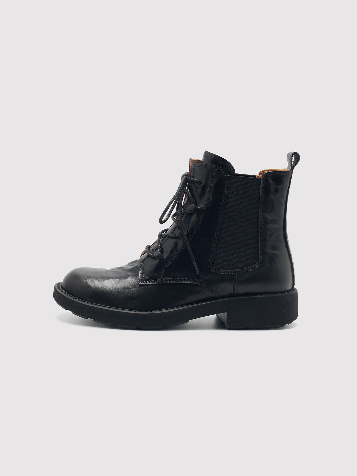 Vegetable-tanned black lace-up boots, side profile.