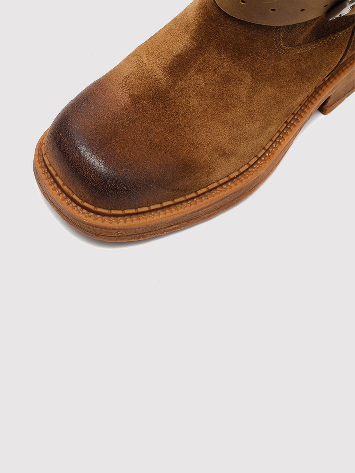 Brown Spanish-inspired buckle boots, close-up of the toe and sole edge.