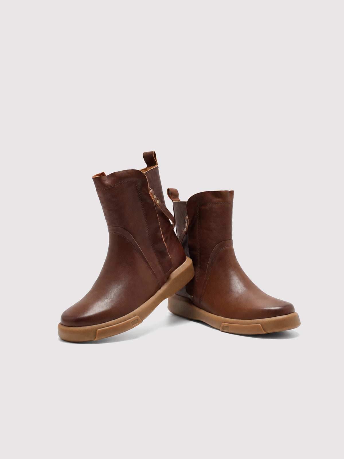 Brown double-zip leather boots, pair arranged at different angles.