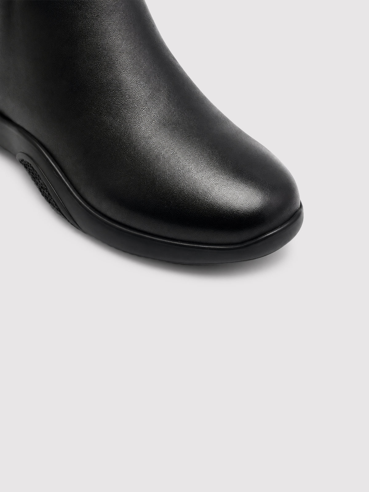 Black lambskin sock boots, close-up of the toe and sole edge.