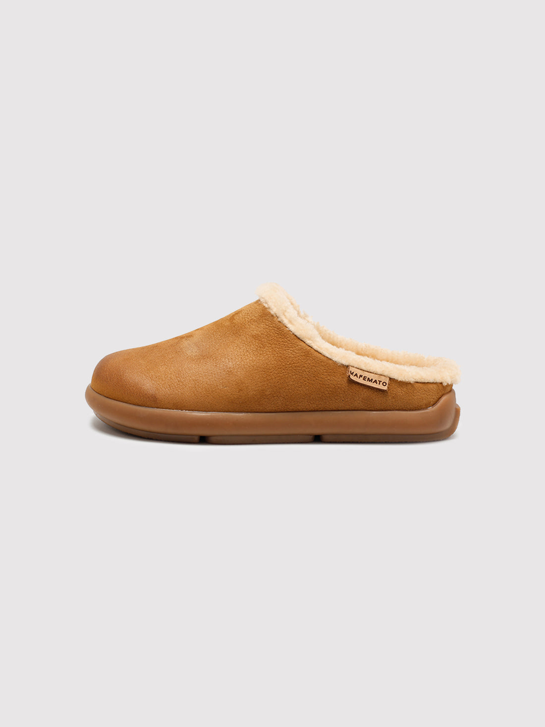 Tan Capybara shearling mules, pair viewed from the front at an angle.