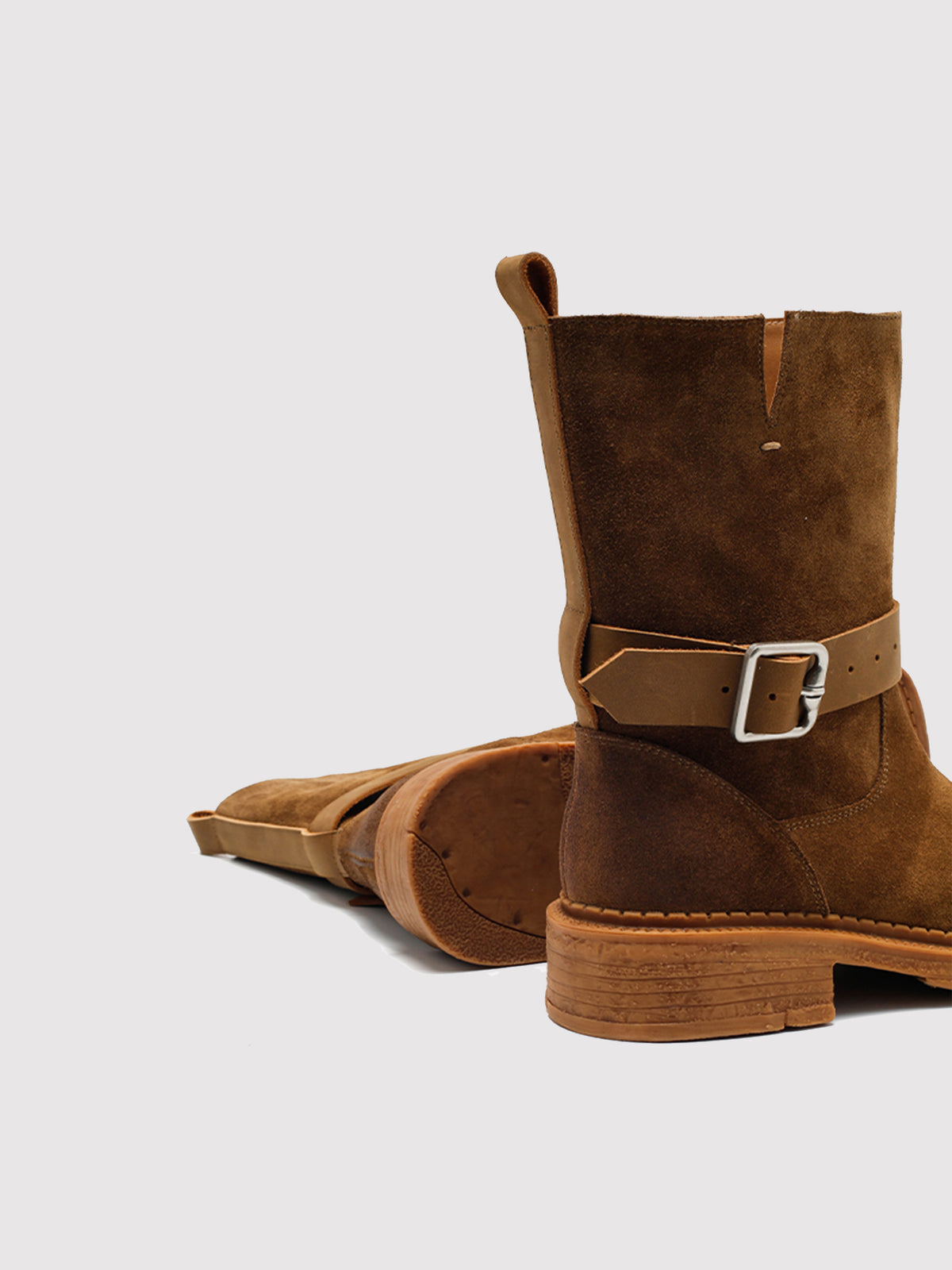 Brown Spanish-inspired buckle boots, pair arranged to show the buckle and side profile.