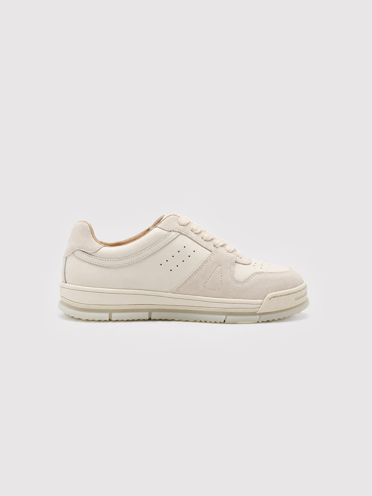 Opposite side of a cream lace-up sneaker with a pale sole.