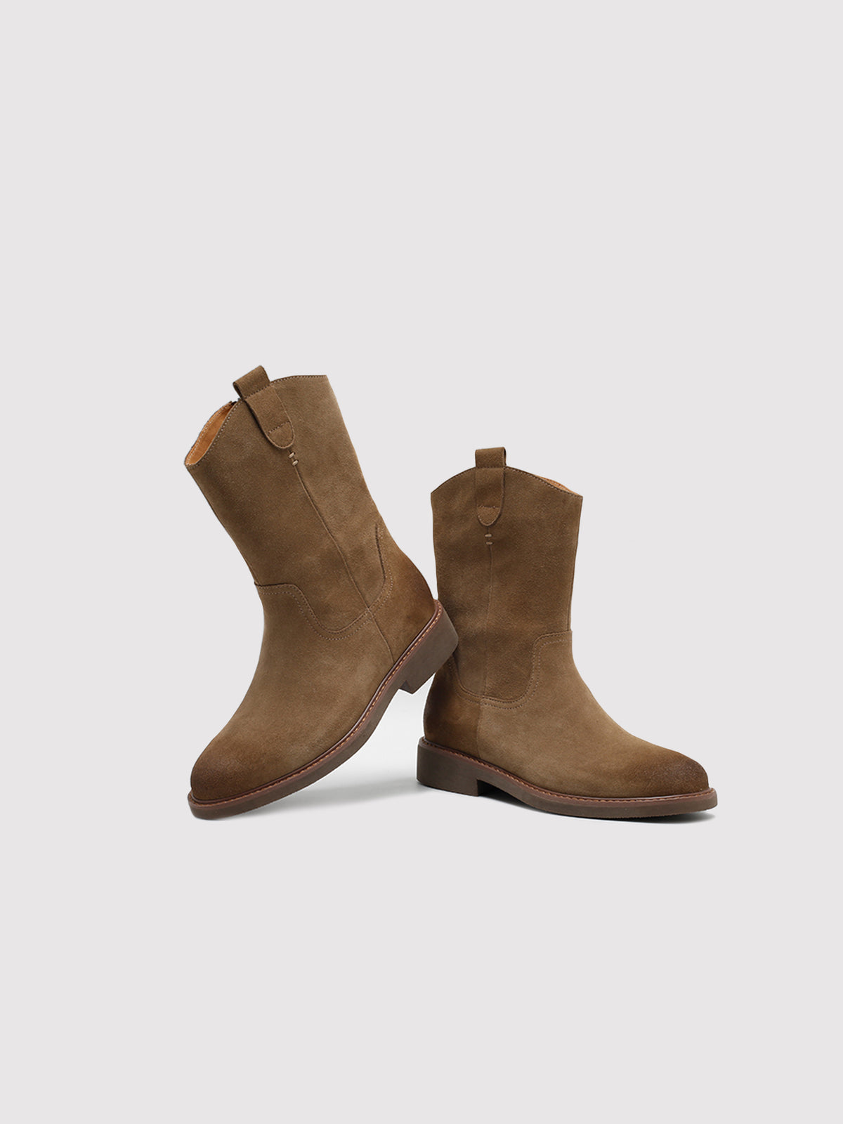 Tan pointed-toe boots, pair arranged at different angles.
