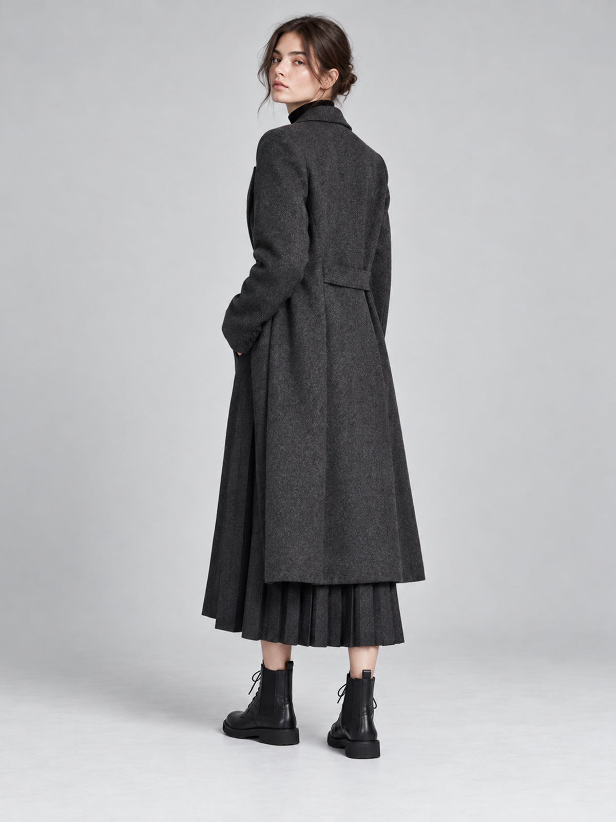 Vegetable-tanned black lace-up boots, worn with a long black dress.
