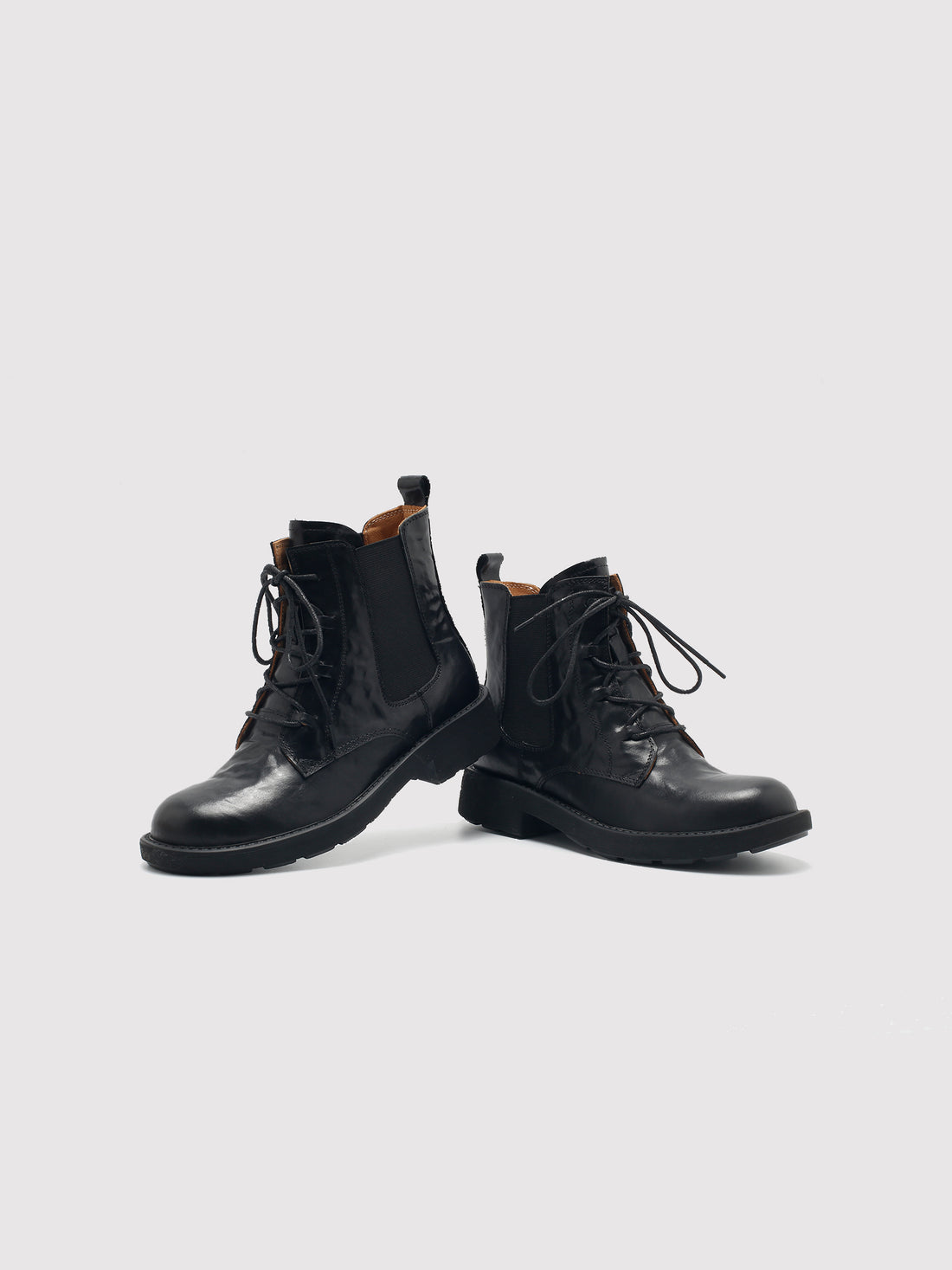 Vegetable-tanned black lace-up boots, pair viewed from the front at an angle.