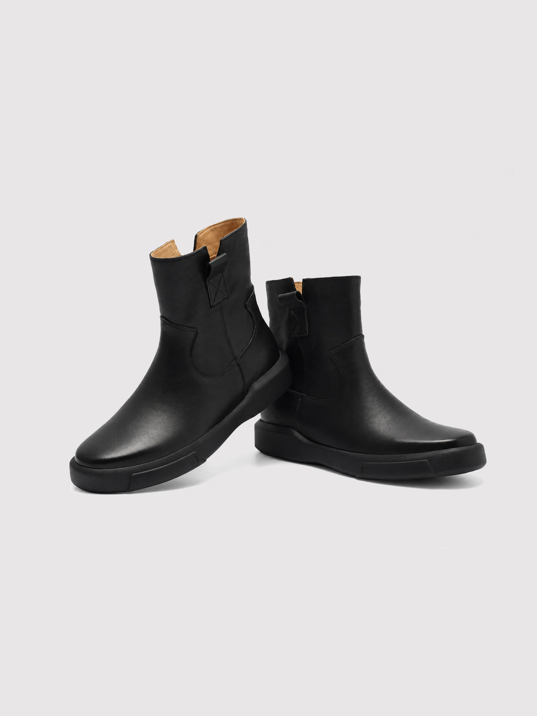 Black zip ankle boots, pair viewed from the front at an angle.