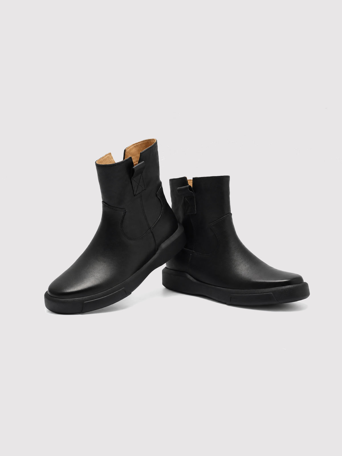 Black zip ankle boots, pair arranged at different angles.