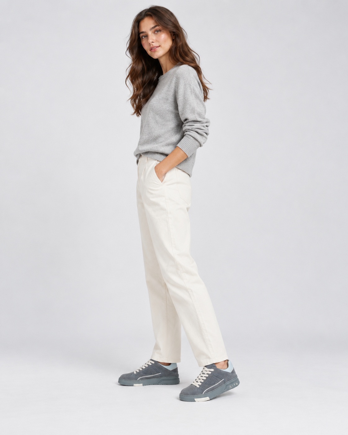 Grey Two-Way low-top sneakers, worn with cream trousers and a grey top.