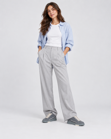 Gray lace-up sneakers, styled with gray wide-leg trousers and a blue shirt.