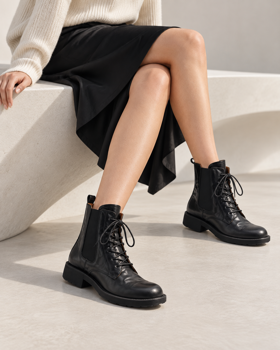 Vegetable-tanned black lace-up boots, close-up of the shoes being worn.