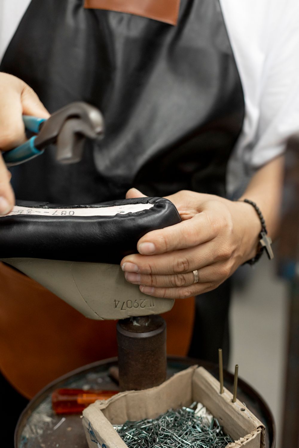 Shoemaker working by hand