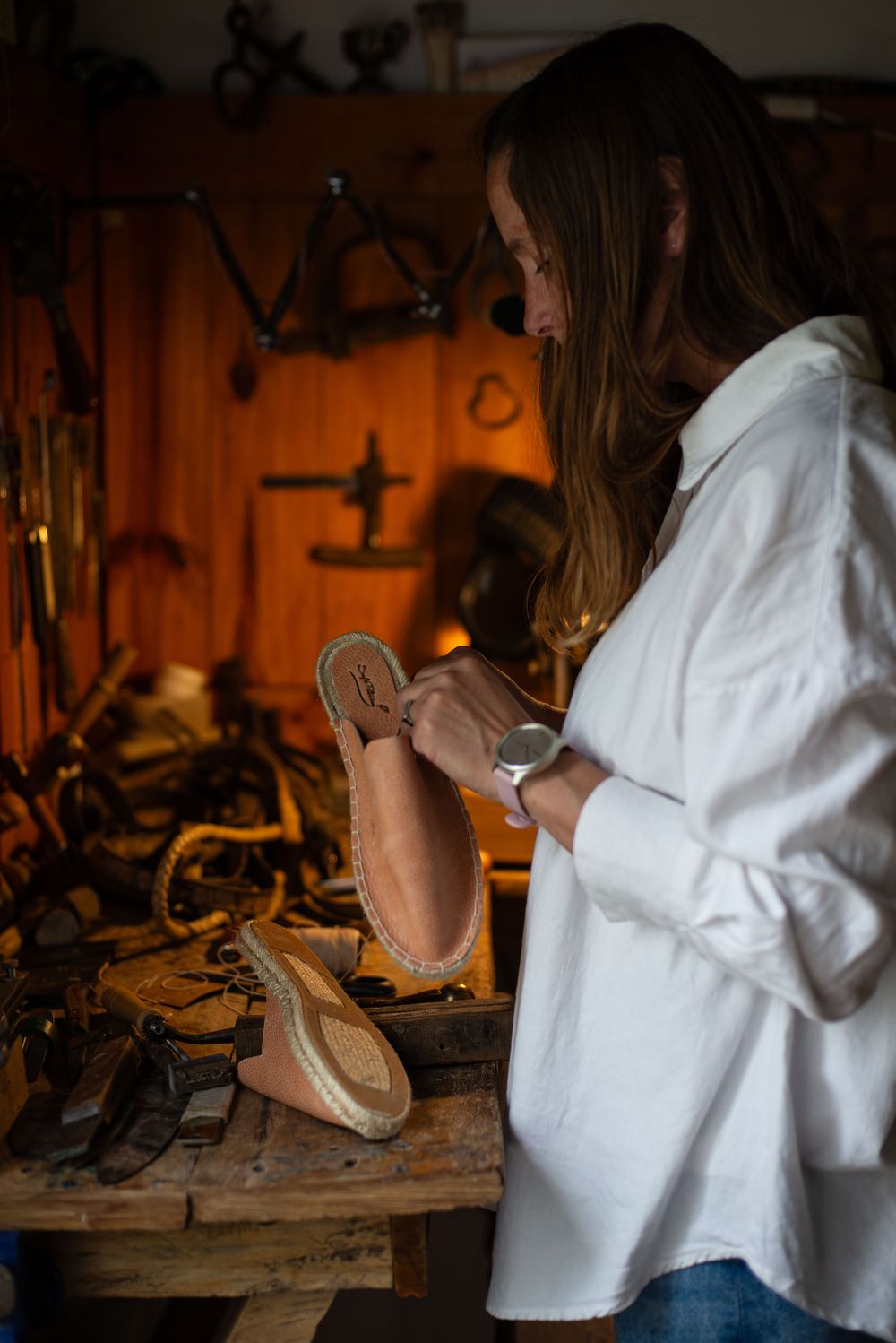 Craftsperson inspecting leather shoes